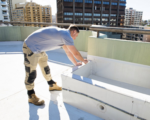 Man fixing a cracked wall